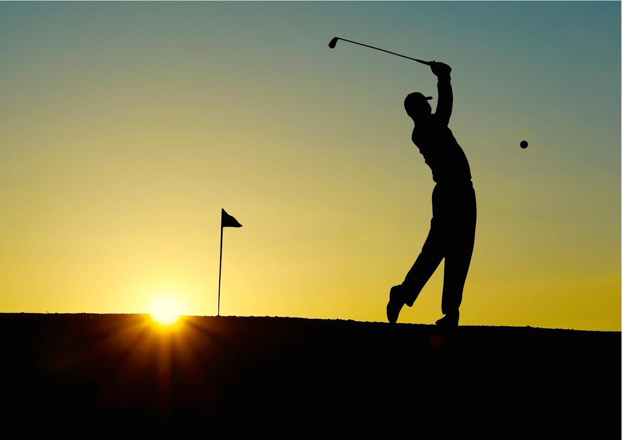 Silhouette of a golfer swinging at sunrise, capturing the essence of the sport.